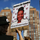 A woman holds a poster bearing the portrait of Sandra Bland, a 28-year-old black woman who reportedly killed herself in a Texas jail cell on July 13th, during a Michael Brown memorial rally on Union Square August 9, 2015 in New York.